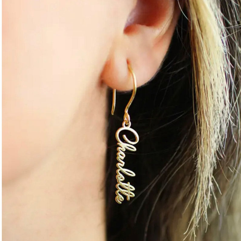 Close up photo of gold drop earrings from custom name jewelry