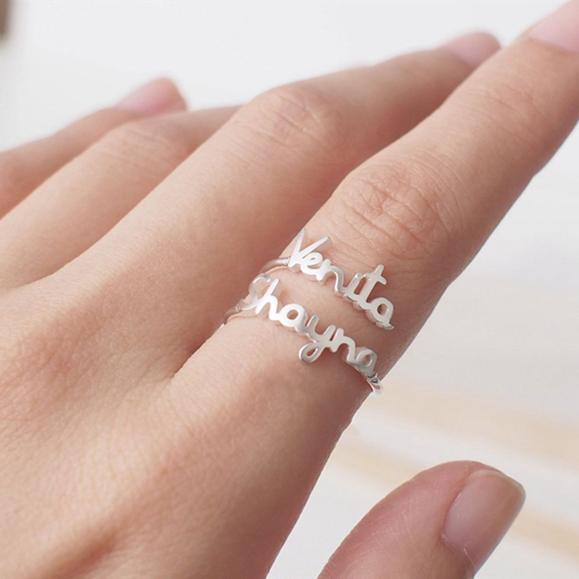 Custom Name Jewelry's double-name rings in 18-karat silver plated.