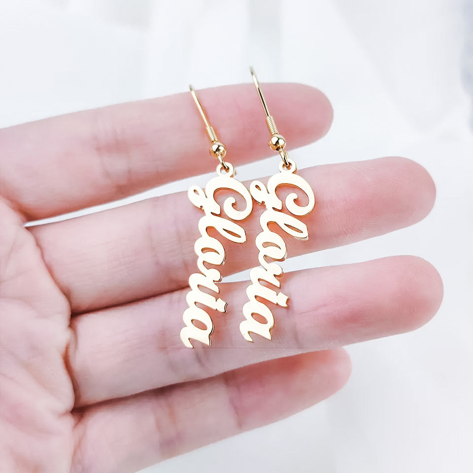Close up photo of gold drop earrings from custom name jewelry