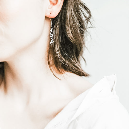 Introducing our Custom Name Dangle Earrings! These beautiful earrings are the perfect way to show off your unique style and make a statement. Whether you're looking for something special for yourself or as a gift, these earrings are sure to be treasured.